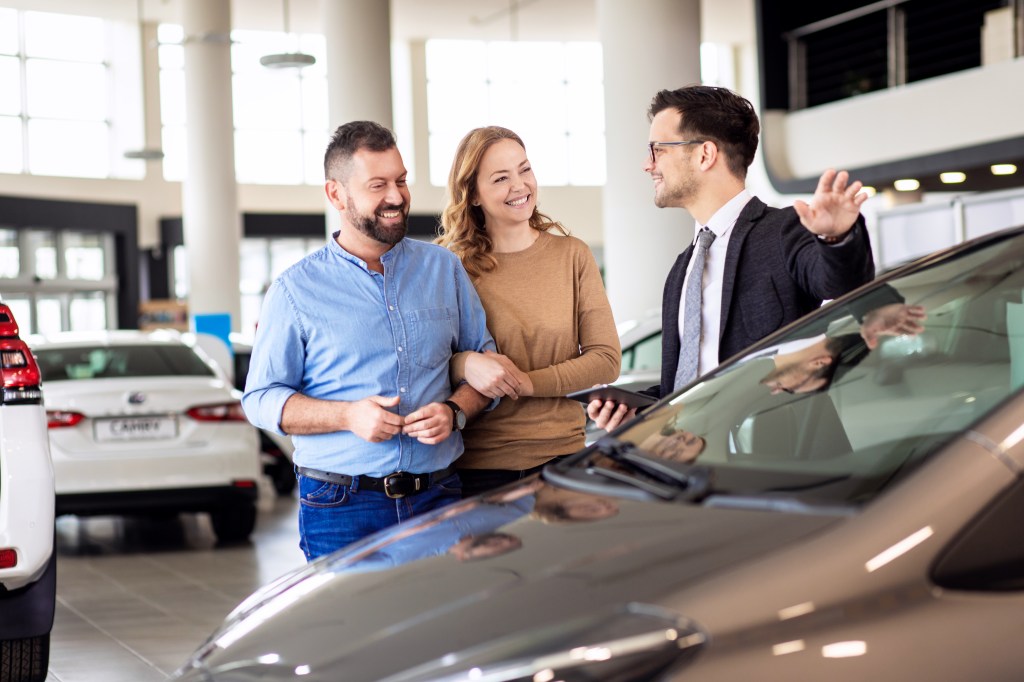 Car shoppers with salesperson